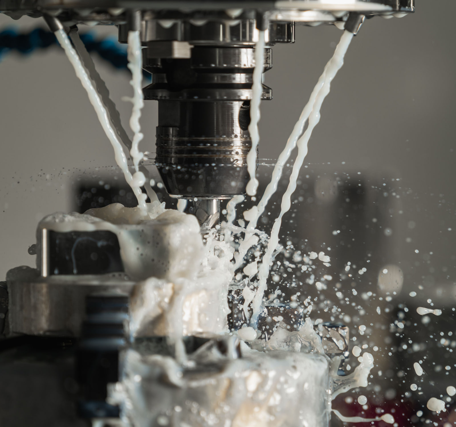 A CNC machine cutting a metal component under coolant